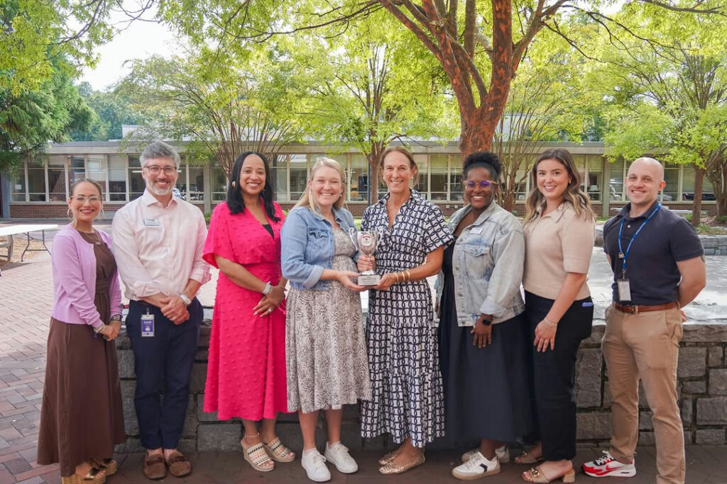 Photo shared by The Lovett School on October 09, 2025 tagging @lovettalumni. May be an image of one or more people, people smiling, people standing, office and text.