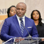 Photo shared by Atlanta Public Schools on October 30, 2025 tagging @apsboe, and @apssupt. May be an image of one or more people, dais and text.